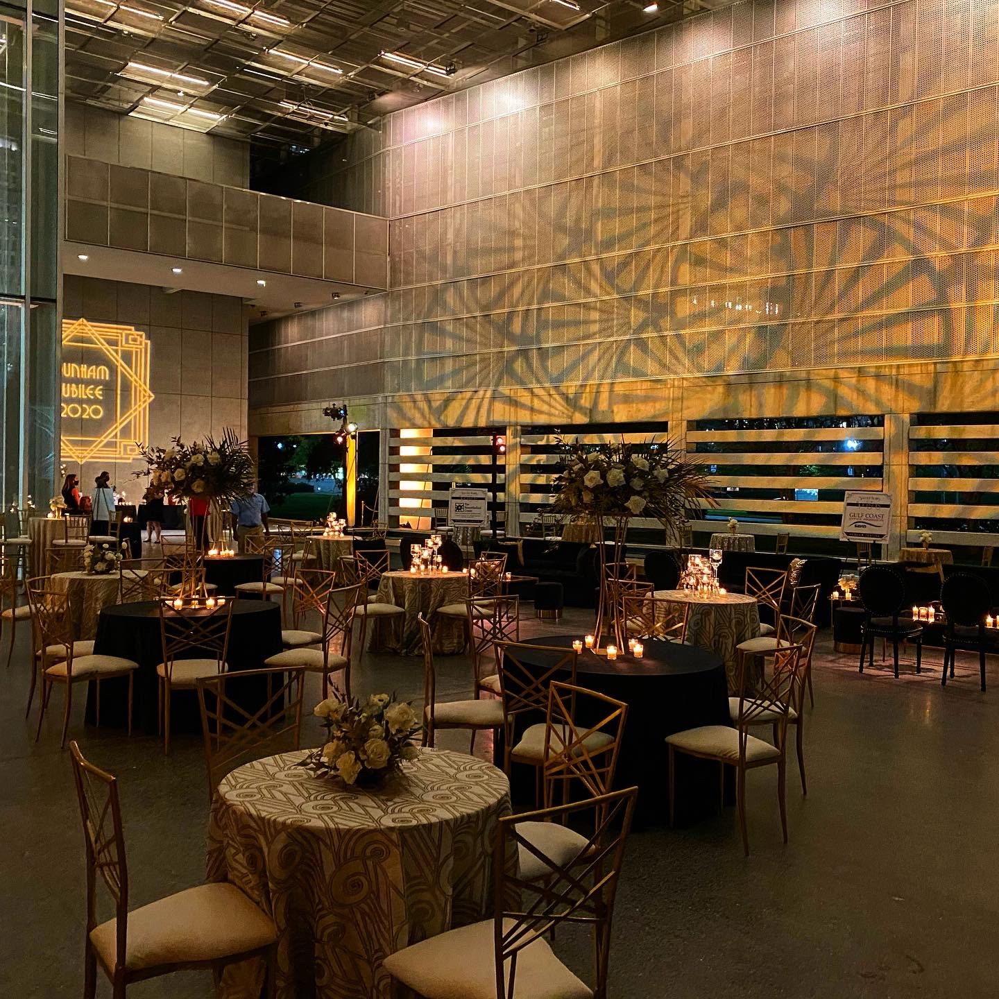 Reception space with warm amber wash lighting and candlelit tables