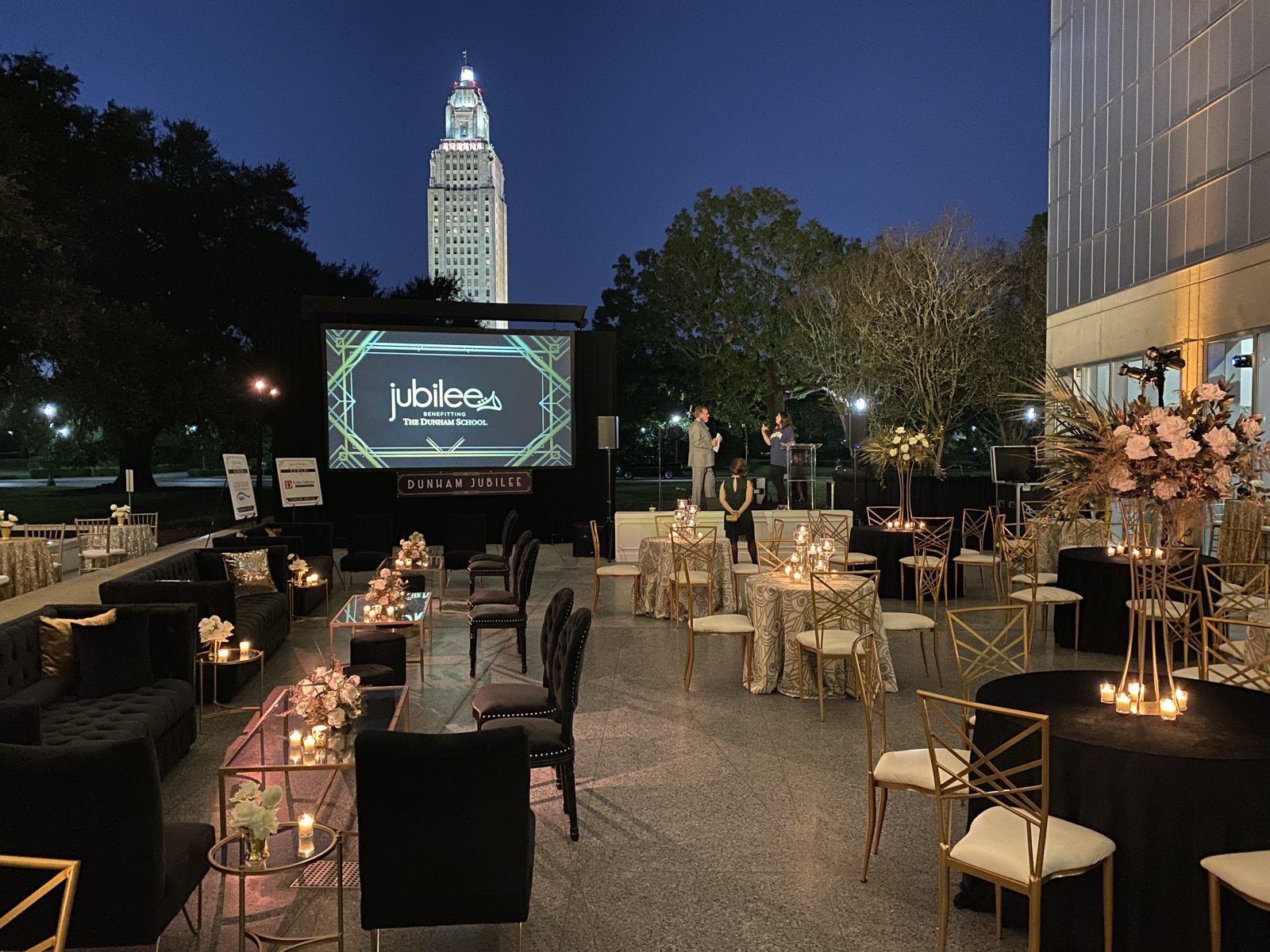 Outdoor evening gala with LED screen and lounge seating in downtown Baton Rouge